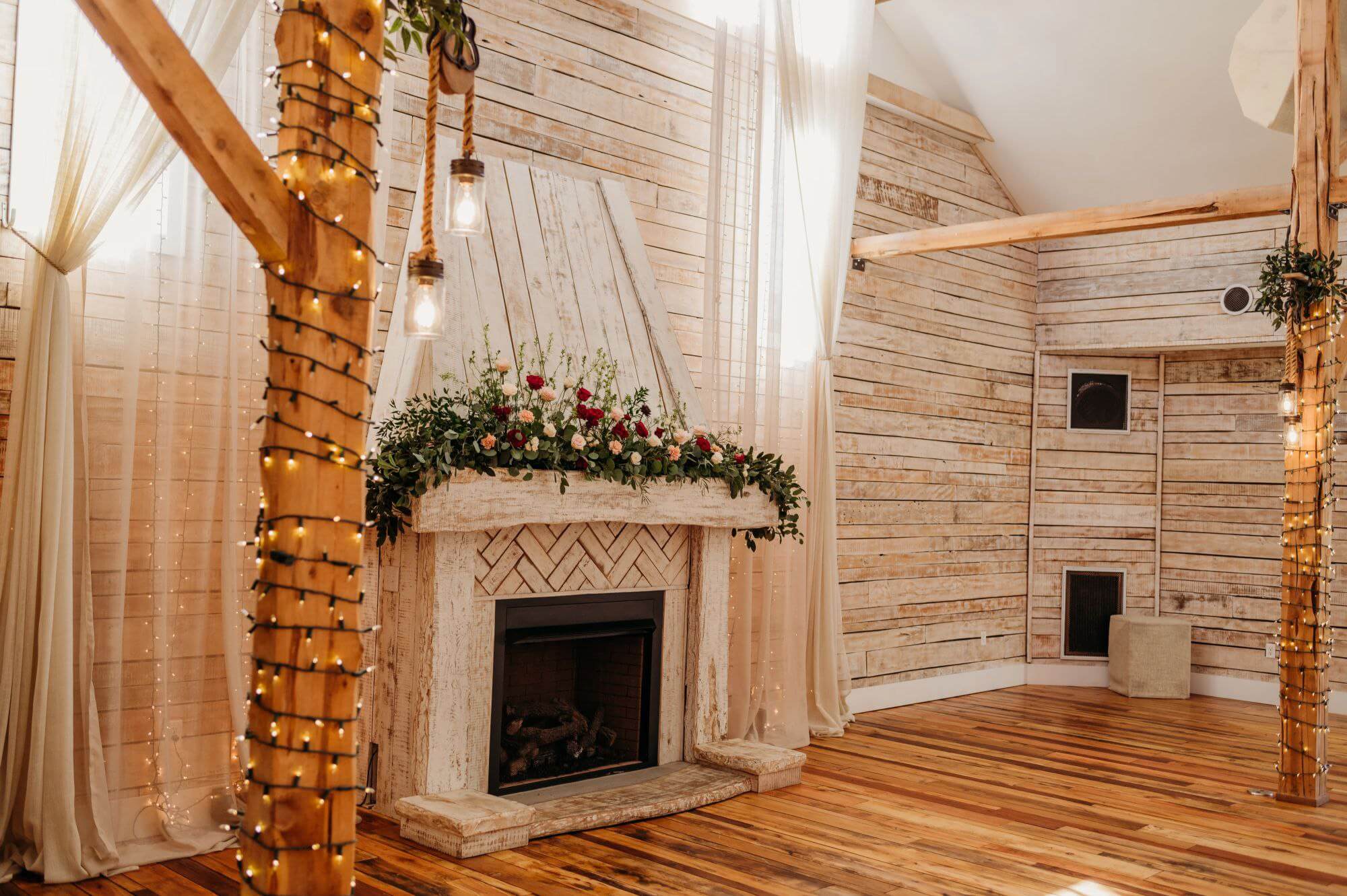 fireplace at Ramble Creek Wedding Venue draped in florals
