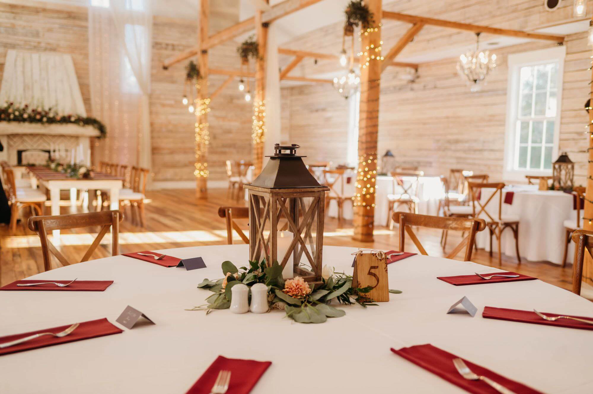 wedding reception table with a lantern and linen napkins