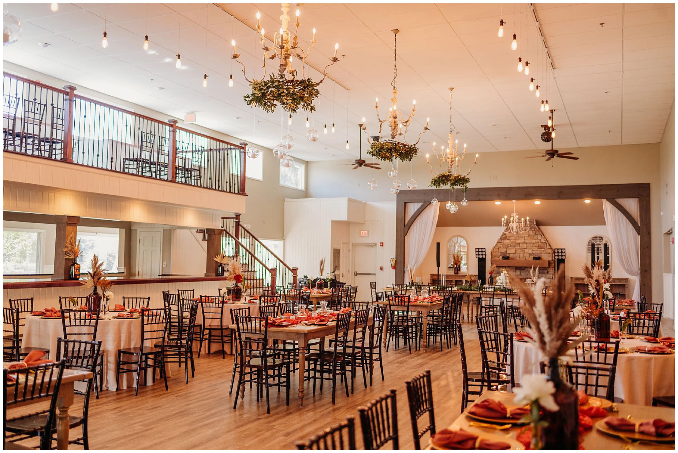 photo of indoors The Venue Chattanooga with wooden tables and chairs, maroon linen napkins, and boho decor