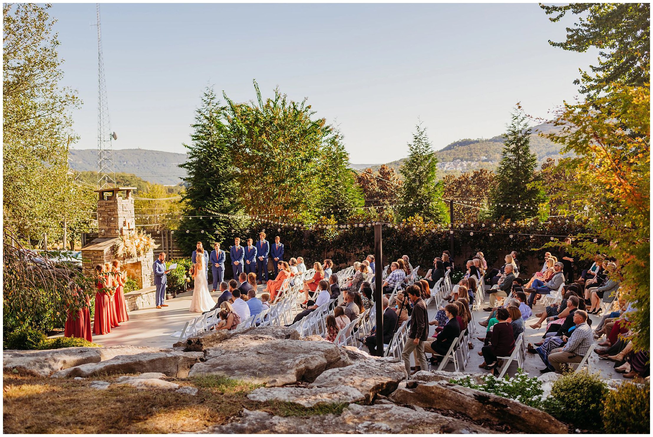photo of the garden at the venue chattanooga with a stone fireplace and mountains in the background